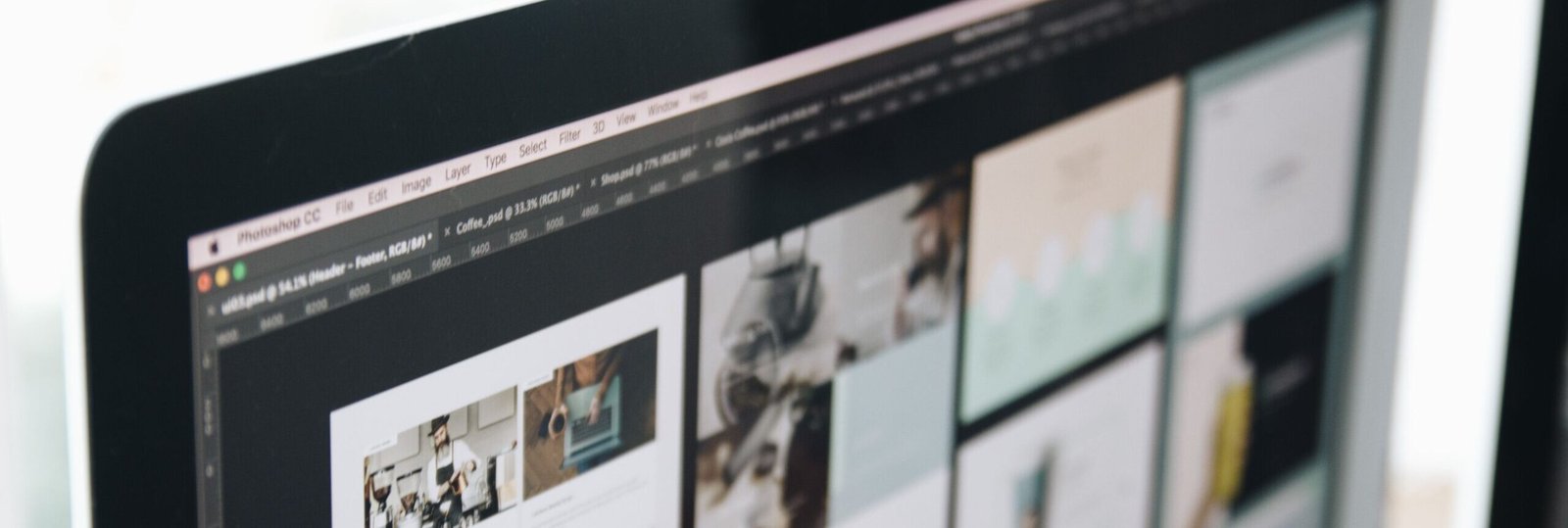 A modern computer screen displaying web design work, showcasing creative visuals in a workspace.